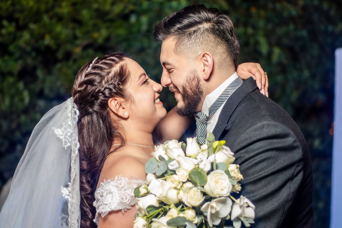 Joyful couple sharing a romantic moment at their wedding in México, embracing with love and happiness.