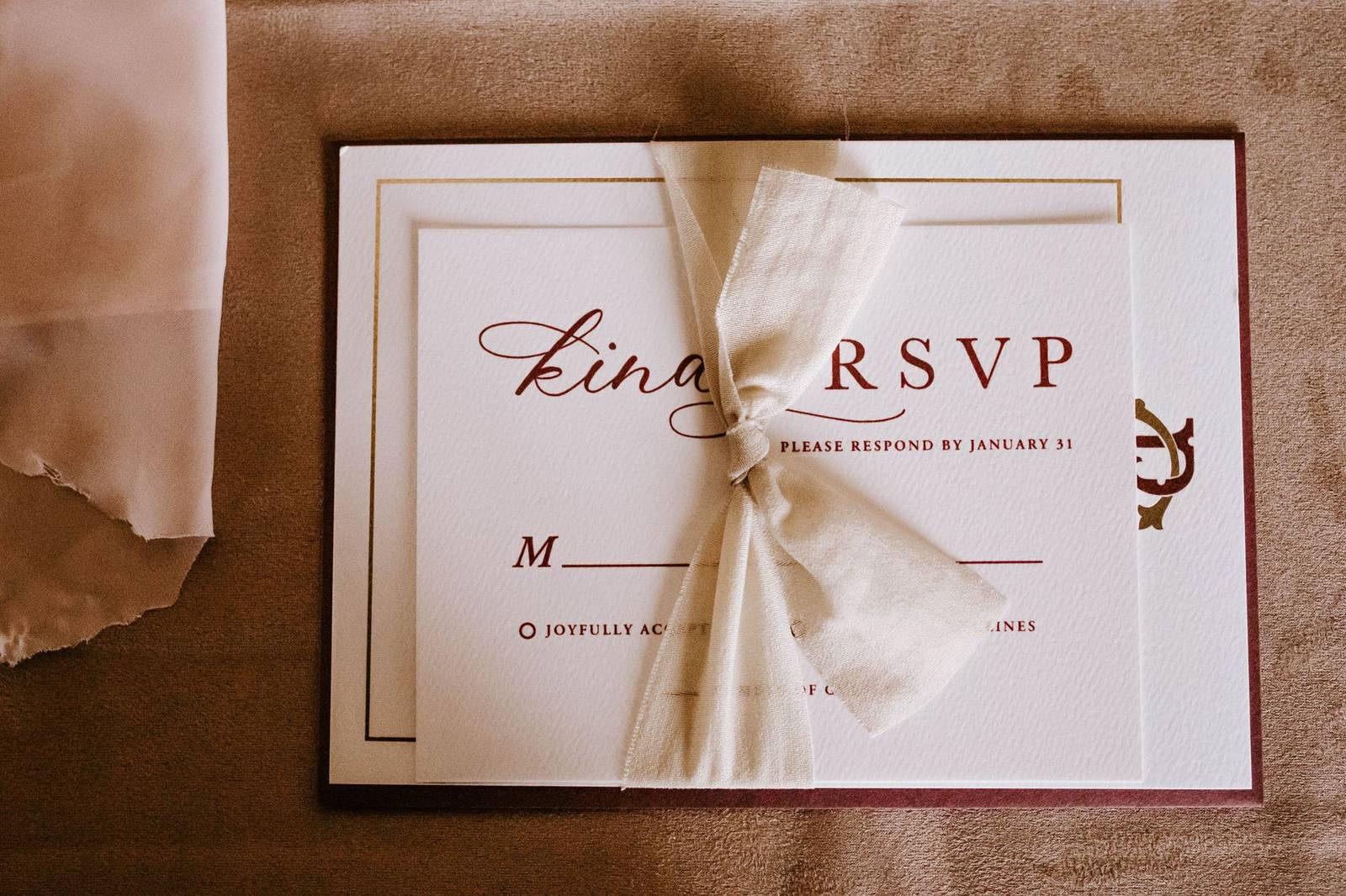 Top view of wedding invitation card for guest with RSVP abbreviation requiring respond from invitee